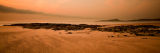 Orange sky above Embleton rocks towards Dunstanburgh Castle